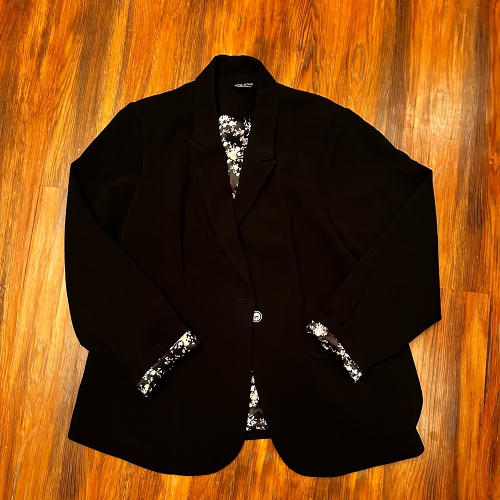 Black blazer with flower print inside.